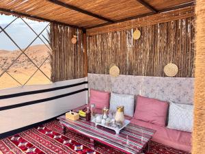a living room with a couch and a table at Night Stars Camp in Badīyah