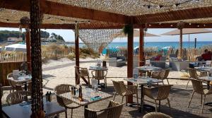 a restaurant with tables and chairs on the beach at Studi'Hotel cœur Sablettes CLIM parking H24 total autonomie in La Seyne-sur-Mer