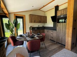 a kitchen with a table and chairs in a room at Austria Parks - Camping Arlberg GmbH in Pettneu am Arlberg