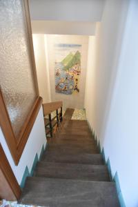 a staircase leading up to a room with a painting at Dalla torre al mare INTERA CASA SU TRE LIVELLI in Vietri sul Mare +40 photos
