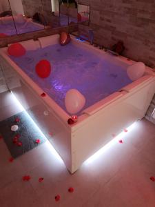 a hot tub with lights in a room at Bijou Suite in Taranto