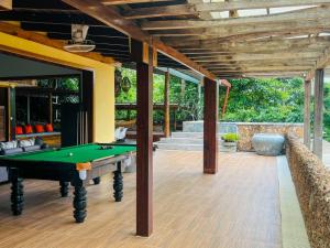 an outdoor entertaining area with a pool table at Veranda Natural Resort in Kep