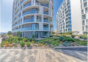 an apartment building with a garden in front of it at Modern Bachelor Suite & Stunning View Pool & Gym in Midrand