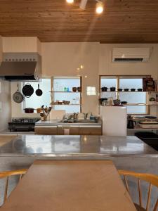 a kitchen with a large stainless steel counter top at Haruhiya in Ishigaki Island
