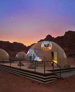 a group of three dome tents in the desert at MARS GATE lUXURY BUBBLE CAMP in Disah