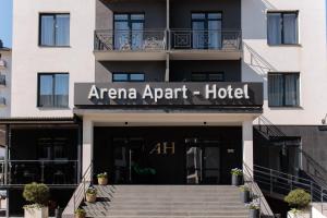 a hotel with a sign on the front of it at Arena Apart - Hotel in Polyana