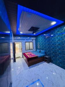 a room with a bed and a blue ceiling at KIYAN VILLA in Daman
