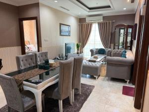 a living room with a table and a dining room at 2 Bedroom apartment at Senayan in Jakarta