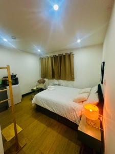 a bedroom with a bed and a table and a window at Stylish Ensuit Studios in the Heart of Vibrant Tooting 1 Min to Tube in London