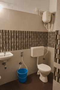 a bathroom with a toilet and a sink at Vibe Stay by Andaz in Arambol
