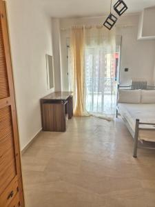 a living room with a couch and a table at Kavala central studio in Kavala