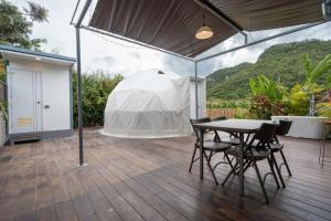 a patio with a table and chairs and a tent at Chavallee Campground in Ban Tha Chang