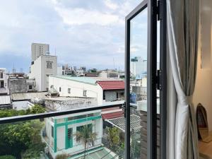 a balcony with a view of a city at Four P Stay Phu Nhuan in Ho Chi Minh City