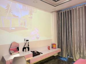 a room with a desk and a painting on the wall at Four P Stay Phu Nhuan in Ho Chi Minh City