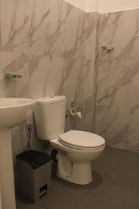 a bathroom with a toilet and a sink at Villa ONE66 in Dambulla