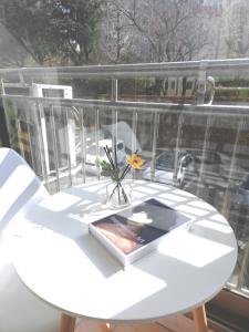 a white table with a book on it on a balcony at Daegu 3 rooms APT All furnished Near downtown & Dongdaegu station in Daegu +9 photos