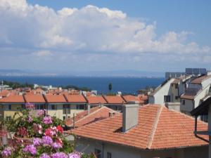 a view of a city with buildings and flowers at Guest house Stoyanovi in Chernomorets