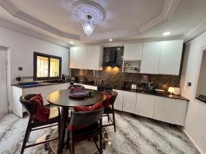a kitchen with a table and chairs in a room at The Gambian Princess in Sukuta