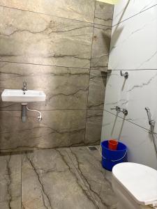 a bathroom with a sink and a toilet at Banasura mount private pool villa in Padinjarathara