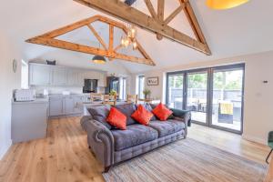 a living room with a couch and a kitchen at Meadow Roost York in York