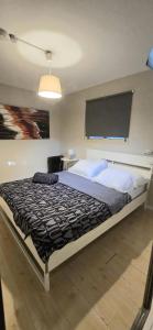 a bedroom with a large bed with a large screen at A Fun Holiday In The Galilee in Sede Eli‘ezer