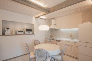 a kitchen with a table and chairs and a refrigerator at COVE KAWANA in Kawana