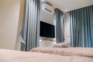 a bedroom with a teddy bear sitting on a bed at ฌานา วิลล์ Chana Ville Udonthani 