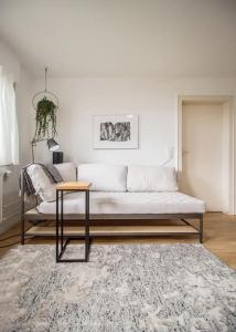 a living room with a white couch and a table at Apartment overlooking Stuttgart in Stuttgart