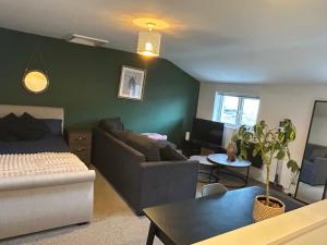 a living room with a couch and a bed and a living room at Sandcastle in Swansea