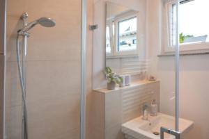 a bathroom with a shower and a sink at Anubis relaxed&stay in Hamburg