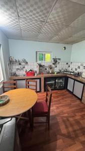 a kitchen with a wooden table and a table and chairs at Mantra Mountain Organic Homestay in Pokhara