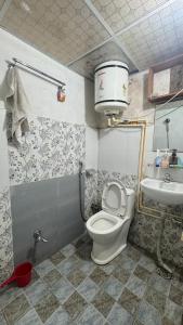 a bathroom with a toilet and a sink at Mantra Mountain Organic Homestay in Pokhara +50 photos