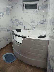 a bathroom with a white tub and a sink at Apartman IN Pančevo in Pančevo