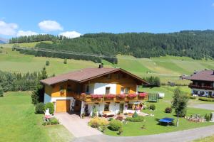 a house with a balcony on a hill at Haus Rosa in Kartitsch