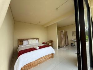 a bedroom with a bed in a room at Pondok Kenali Glamping in Kubupenlokan