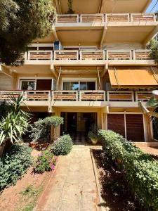 an apartment building with a walkway in front of it at XiangBaLa in Athens