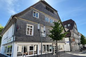 a black and white building on the corner of a street at Charmante 120qm Dachgeschoß-Wohnung in Lippstadt
