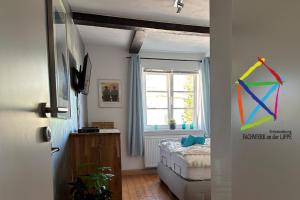 a bedroom with a bed and a window in a room at Charmante 120qm Dachgeschoß-Wohnung in Lippstadt