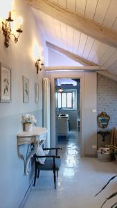 a living room with a table and a hallway at Casa May in Turin