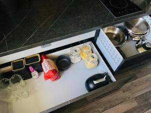 a drawer in a kitchen with various items on it at Black Apartment at Blossom Hill in Tallinn