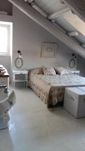 a bedroom with a large bed and a table at Casa May in Turin