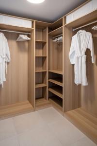 a walk in closet with wooden doors and shelves at ValrasLoc Archipel Panarea Vues Inegalees in Valras-Plage +39 photos