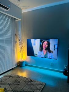 a living room with a flat screen tv on a wall at Condo Center Point Phnom Penh City - Time Square 2 Apartment in Phnom Penh
