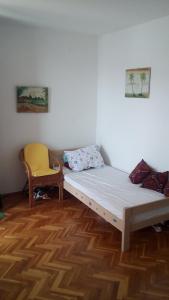 a small room with a bed and a chair at Panoramic sea view Apartment in Španjola +2 photos