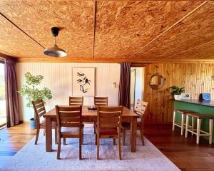 a dining room with a wooden table and chairs at Briar Cottage Weldborough in Weldborough