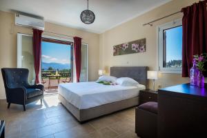 a bedroom with a bed and a chair and a window at Armonia Villas in Lixouri