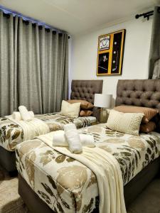a bedroom with two beds and a couch at Urban Contempo Lush in Fourways +28 photos