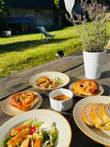 a wooden table with plates of food on it at Vegan House - kamienny pokój in Międzylesie +11 photos