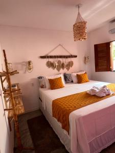 En eller flere senge i et værelse på Lounge Vila Tatajuba