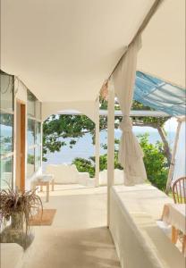 a white house with a view of the ocean at Sea for Rest beach club 